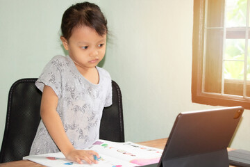 Girls use laptops to study at home, research information, technology concepts and communicate online.