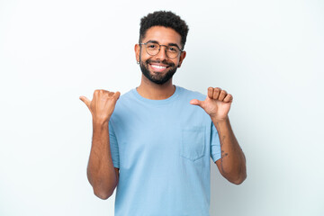 Fototapeta premium Young Brazilian man isolated on white background pointing to the side to present a product