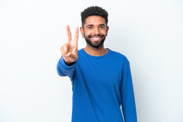 Fototapeta premium Young Brazilian man isolated on white background smiling and showing victory sign