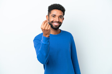 Young Brazilian man isolated on white background making money gesture