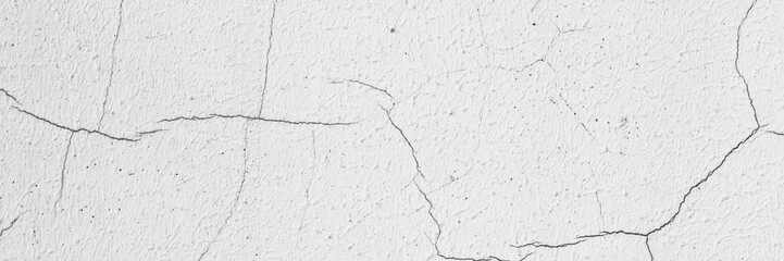 Old wall with cracked plaster. Weathered rough surface. Wide panoramic texture for background and design.