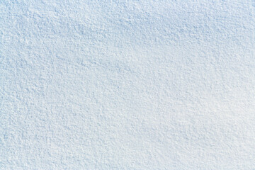 Natural snow texture. Smooth surface of clean fresh snow. Snowy ground. Winter background with snow patterns. Perfect for Christmas and New Year design. Closeup top view.