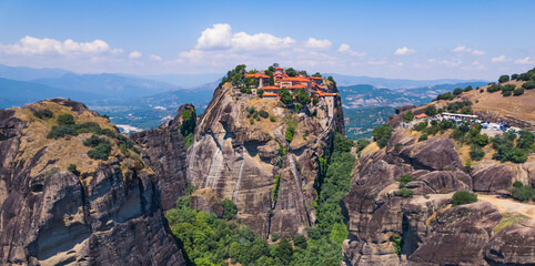 stunning aerial view of the famous monasteries on the tops of stone pillars in Meteora in the sunny weather, Greece. High quality photo