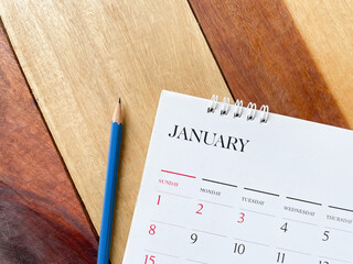Calendar January with pencil on wood texture.
