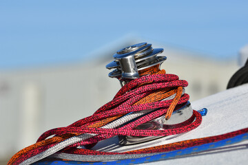 Details of winch and ropes on sailing boat racer. Boating concept. Blurred background . Horizontal view 