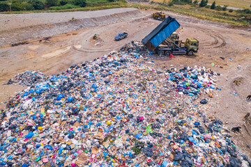 aerial view of a dump truck unloading waste on a landfill. High quality photo