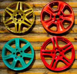 Set of a colorful wheel caps on the wooden wall. Ukraine, Odessa - car service. Background picture.