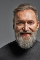 Smiling grey hair caucasian man looking at camera