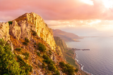 Fototapeta premium amazing panoramic view from a high rock to sunset or sunrise sea in evening or morning with coastline