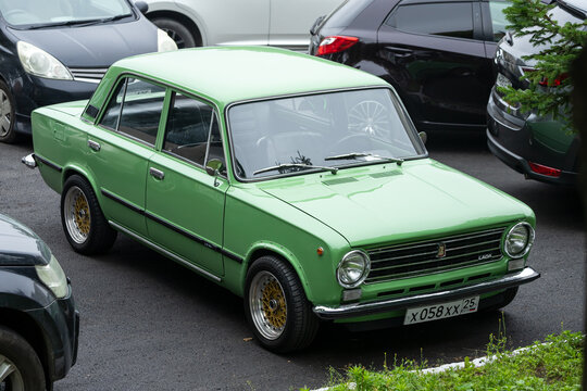 Vladivostok, Russia - July 14, 2022:  green VAZ 2101   is parked  on the street on a warm summer day against the backdrop of a parking