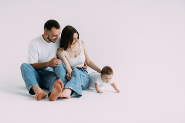 Young family: mother, father and baby son on white background