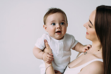 Happy young mother with her son over white background