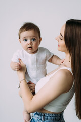 Happy smiling mother with baby having fun together isolated on white background