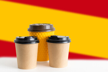National flag of Spain, on the tablet cup of hot drink coffee or tea on the table