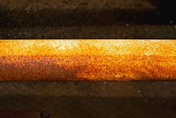 Rusty steel pipe, Steel pipes are placed in the factory, steel pipe for manufacturing. Old yellow pipe on a dark background