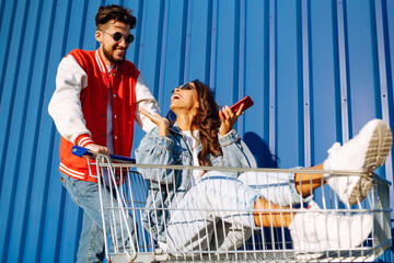 Selfie time. Young friends holding mobile phone taking selfie photo using smartphone camera....