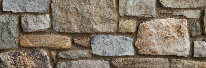 Panoramic image. Stone wall background. Rustic stone wall