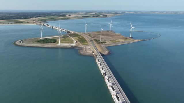 The Oosterscheldekering is a flood defense system in the Netherlands , part of the Delta Works ,in the provinces of Zeeland. WIndmills sustainable energy generation.