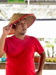 portrait asian man wearing traditional hat from woven bamboo