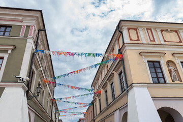 A colorful garland against the background of a beautiful historic, renaissance tenement house. Zamosc, Poland © p  a  t  r  i  c  k