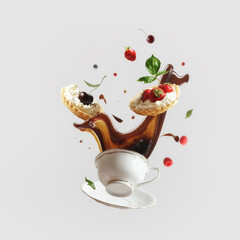 Creative levitation food concept with flying coffee splashing in cup and cakes with various berry...
