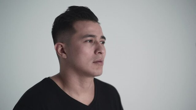 Young hispanic model posing for a photo shoot in a white studio