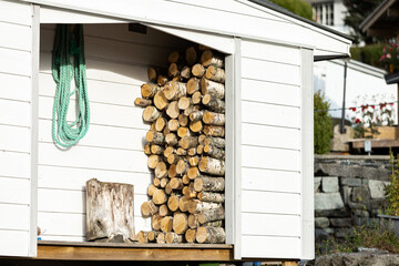 A stack of firewood at a country house. Fuel for furnace heating