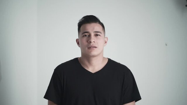 Hispanic man giving a serious look at the camera in slow motion 