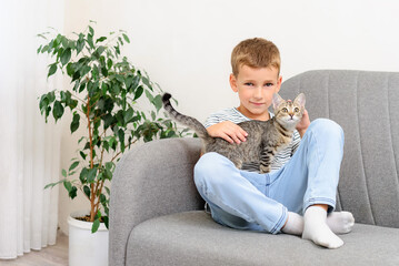 boy with a kitten sitting on the couch