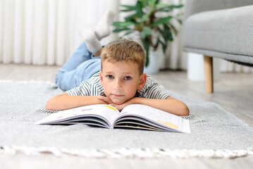 boy lying on the floor with a book