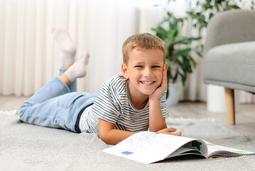 boy lying on the floor with a book