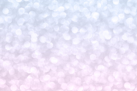 Abstract background with gradient blue and pink blurred small circles.