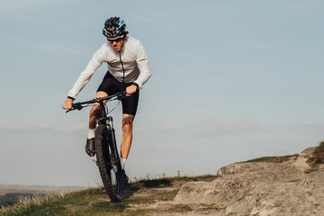 Professional Male Cyclist Riding Bike, Adult Equipped Man on Bicycle on Top of the Hill, Copy Space...