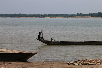 Natural scenery of jadukata river, Tahirpur, Bangladesh. young boy is controlled a boat.