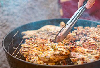 man chef cooking chicken meat on grill outdoor