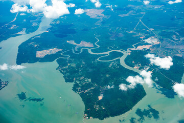 Aerial view from the plane window of Sungai Belungkor mangrove forest, Johor, Malaysia.