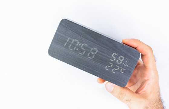 Man holding electronic watch on white background