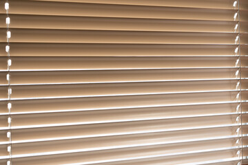 Blinds on the window. Light passing through the blinds