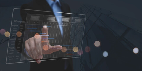 Project management concept. Project manager updating tasks and milestones progress planning with Gantt chart scheduling interface on virtual screen © tippapatt