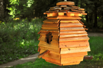 wooden birdhouse in the green park	