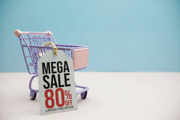Mega Sale 80% off text message on price tax with shoppint trolley cart on blue and pink background
