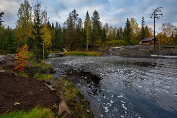 Fototapeta na wymiar Russia. Republic of Karelia. Calm backwaters at the foot of flat waterfalls on the Tohmajoki River near the Ruskeala marble quarry.