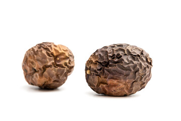 Two expired dried and spoiled passion fruits isolated on white background.