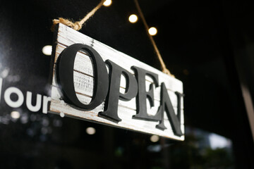 Open sign hanging front of cafe .