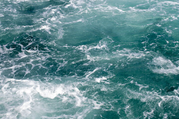 Fototapeta na wymiar Sea surface. Turquoise sea water. Close up blue water surface at deep ocean