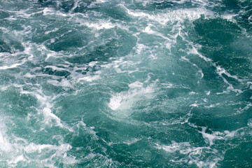Fototapeta na wymiar Sea surface. Turquoise sea water. Close up blue water surface at deep ocean