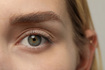 Beautiful woman with grey eye, closeup view