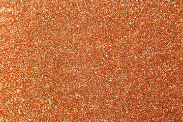 Beautiful shiny orange glitter as background, closeup