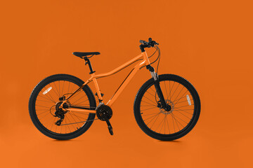 Modern bicycle on orange background. Healthy lifestyle
