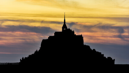 Silhouette of Mont Saint-Michel at sunset.